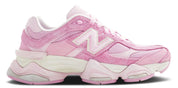 A pair of New Balance 9060 pink overdye sneakers with a mesh upper and a rubber sole.