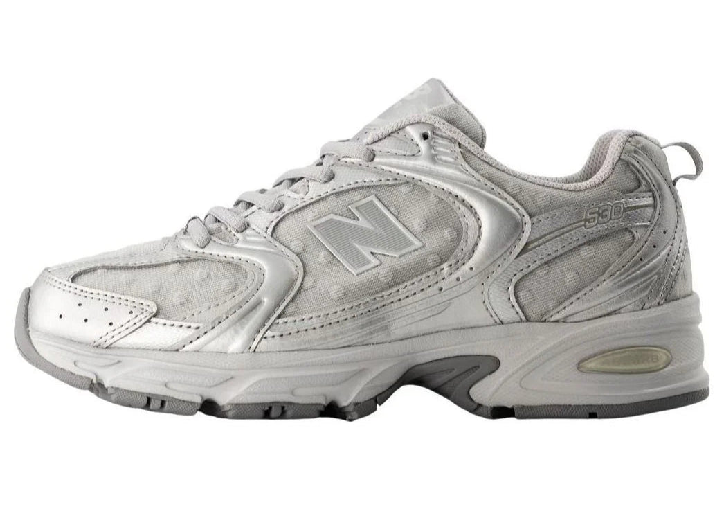 Gray athletic shoe with New Balance logo on a white background