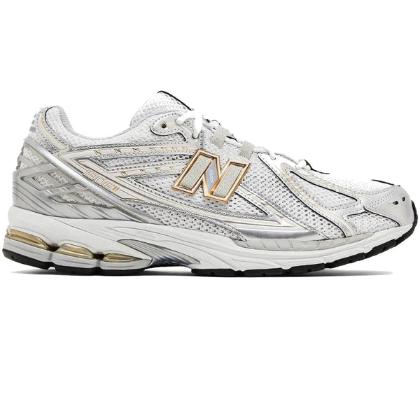 White athletic shoe with gold accents on a white background