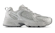 Gray sneaker with New Balance logo on a white background