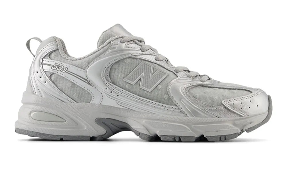 Gray sneaker with New Balance logo on a white background