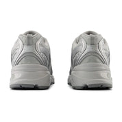Gray athletic shoes shown from the back on a white background