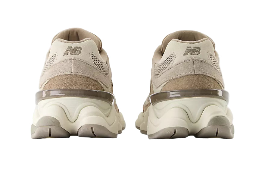 Pair of beige sneakers on a white background
