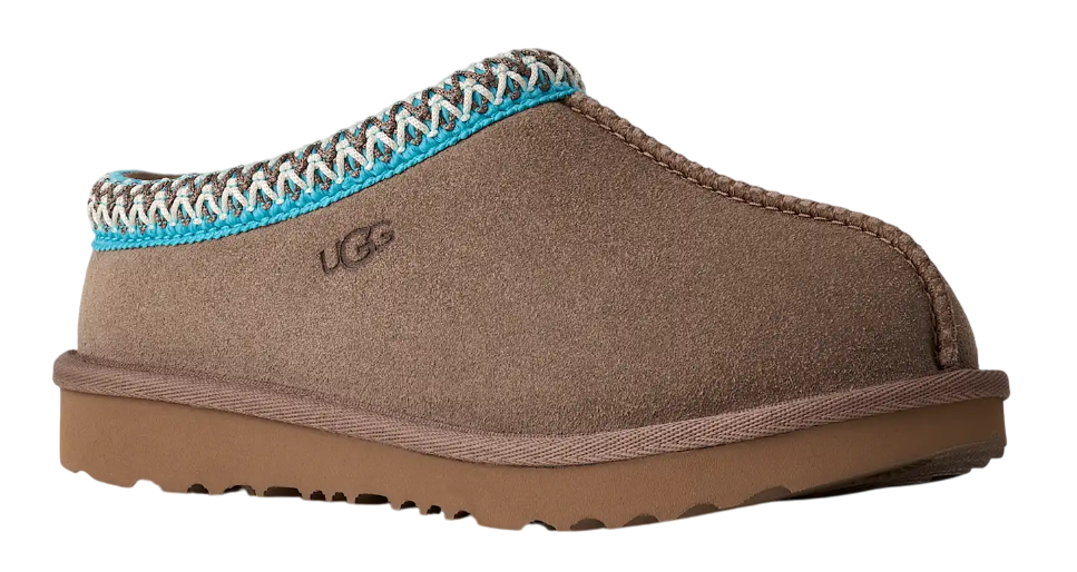 Brown UGG slipper with blue and white trim on a white background