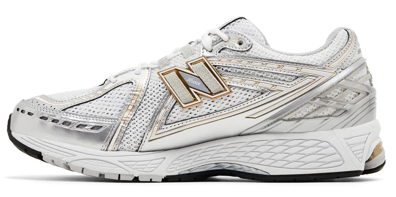 White running shoe with gold accents on a white background