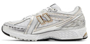 White running shoe with gold accents on a white background