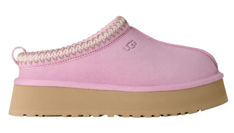 Pink slipper with brown sole on a white background