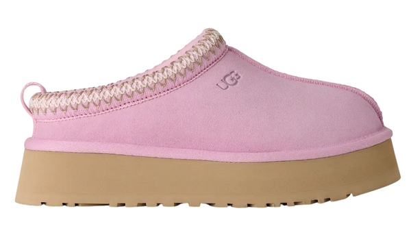 Pink slipper with brown sole on a white background