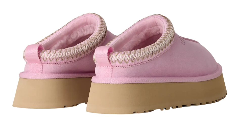 Pair of pink slippers with brown soles on a white background