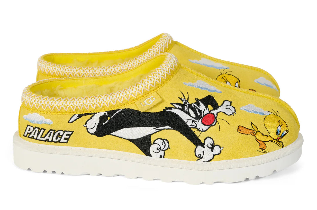 Yellow slippers with cartoon characters and 'Palace' branding on a white background