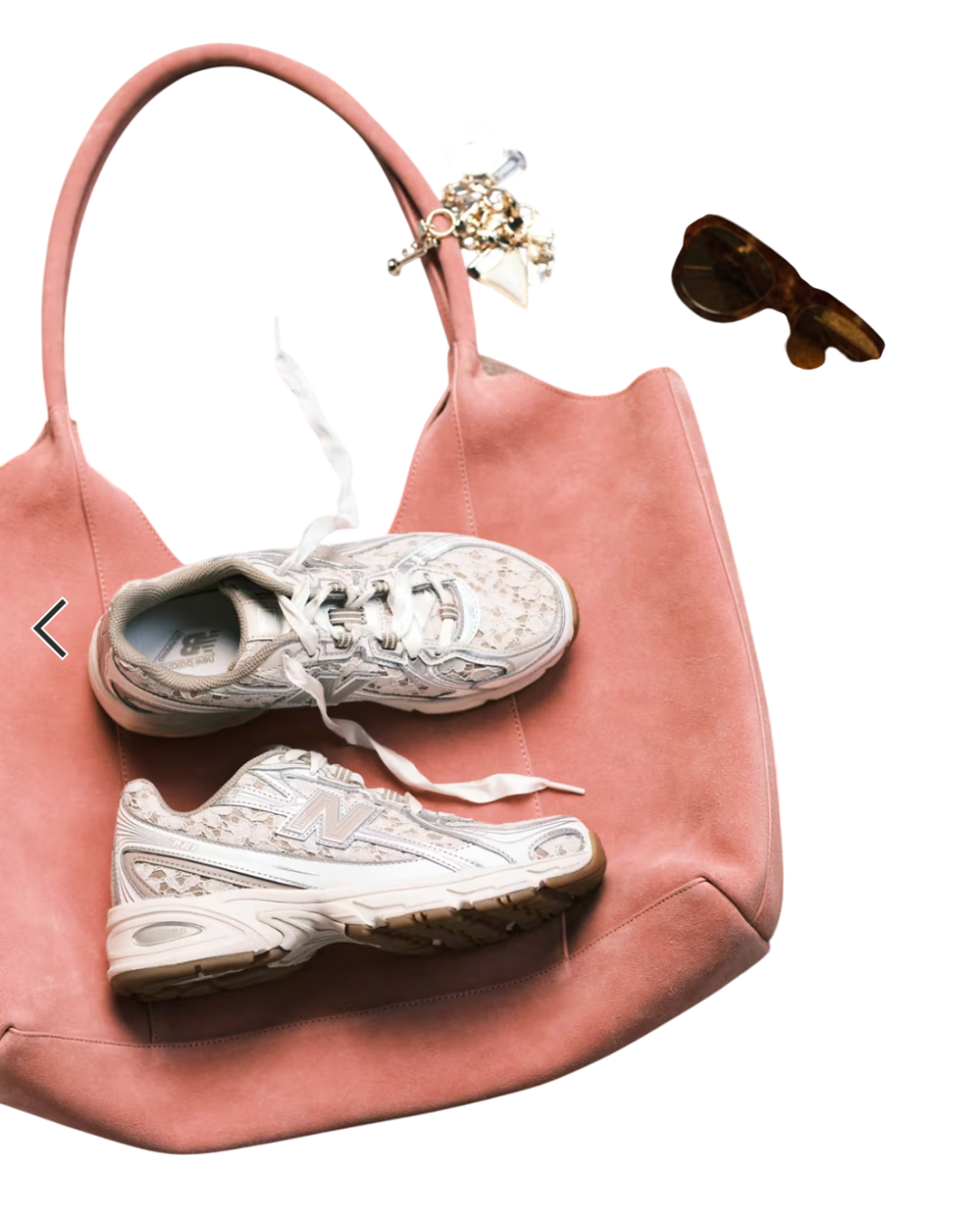 Pink handbag with white sneakers and gold jewelry on a white background