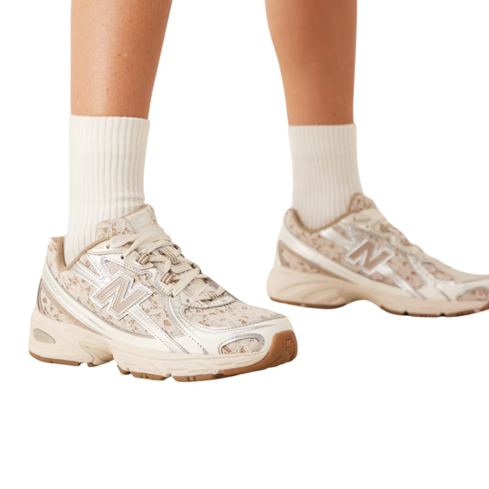 Beige sneakers worn with white socks on a white background