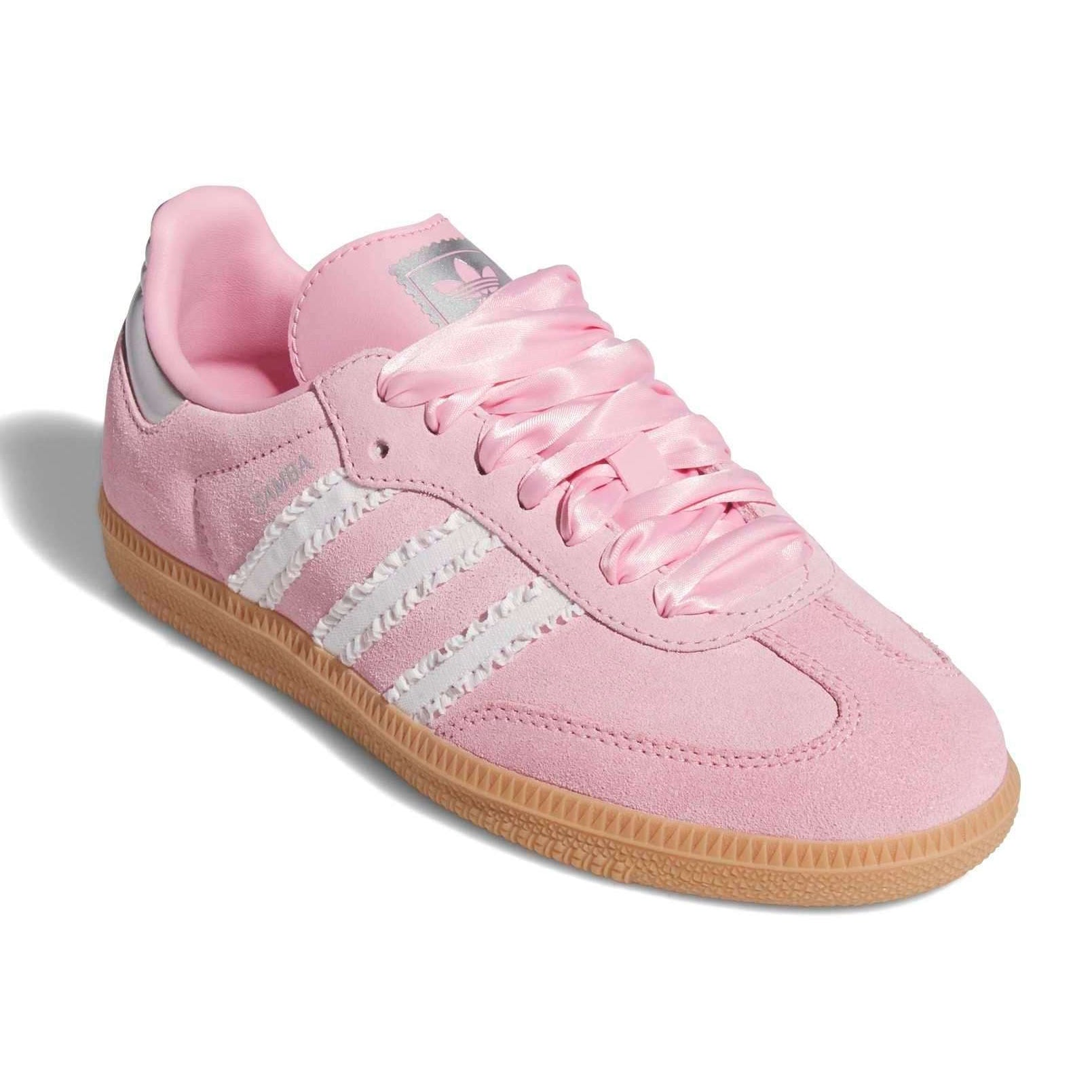 Pink Adidas sneaker with white stripes on a white background
