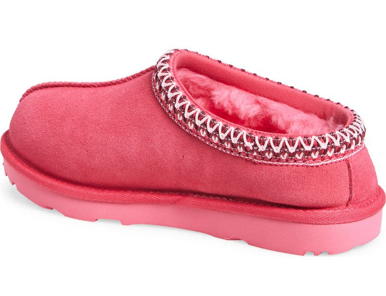 Pink slipper with decorative trim on a white background