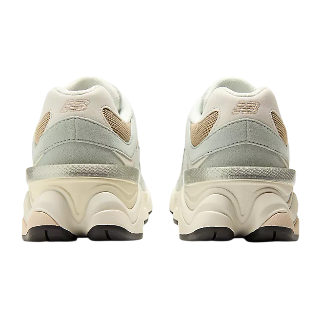 Pair of light gray sneakers with New Balance logo on a white background